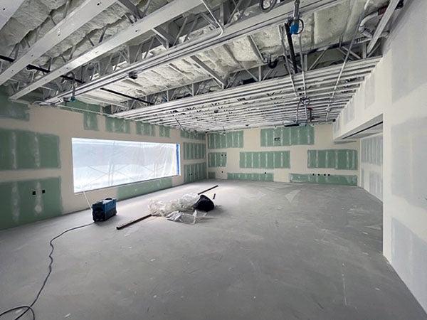 a large room with unpainted drywall