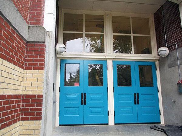 two double blue doors with windows above