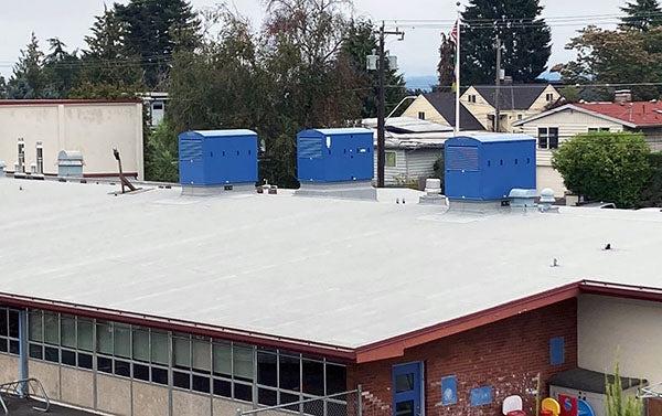 blue boxes sit on a flat roof